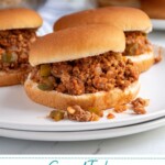 Pinterest Pin with text over lay 'Ground Turkey Sloppy Joes", image of a bun filled with sloppy joes on a plate.