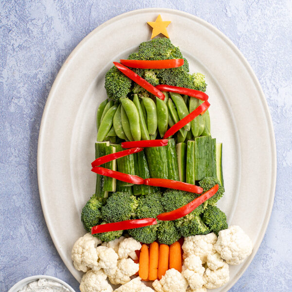 Overhead view of a Christmas Tree Vegetable Tray using tree vegetables to make a tree shape with colorful vegetables as garnishes.
