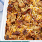 Pinterest Pin with text overlay "Hash Brown & Bacon Breakfast Casserole", image of a white casserole dish with a baked breakfast casserole.