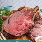 Pinterest Pin with text overlay 'how to make prime rib', image os a cut of prime rib up against a large prime rib roast on a cutting board.
