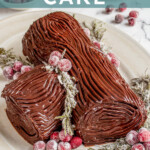 Pinterest pin with text overlay "Yule Log Cake", image of a chocolate roll up cake with whipped filling and a chocolate ganache frosting that looks like tree bark.