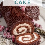 Pinterest pin with text overlay "Yule Log Cake", image of a chocolate roll up cake with whipped filling and a chocolate ganache frosting that looks like tree bark.