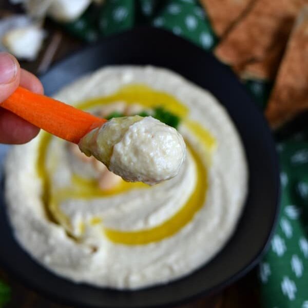 Roasted Garlic White Bean Hummus on a carrot stick