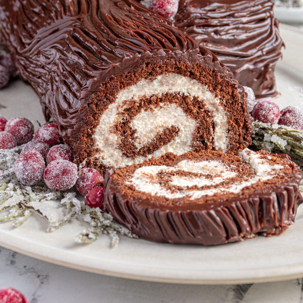 Close up of the yule log cake cut open showing the rolled center.