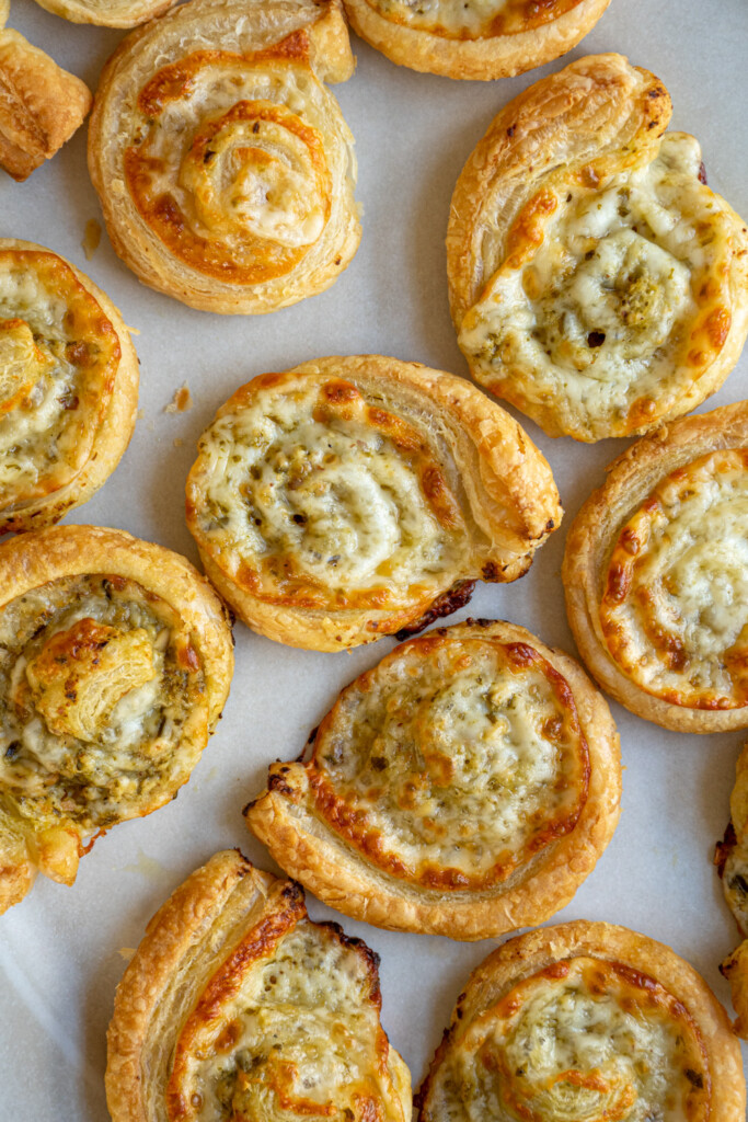 Overhead view of pesto pinwheels on a white platter.