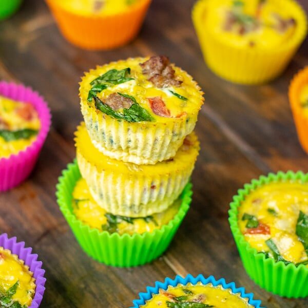 a stack of fresh cooked spinach sausage egg muffins