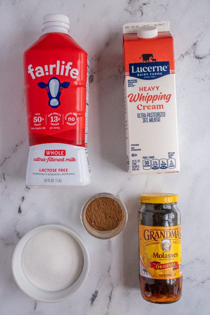 Ingredients needed to make homemade gingerbread ice cream laid out on a tabletop.