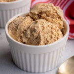 Pinterest Pin with 'The Schmidty Wife' logo, image of a white bowl filled with light brown colored homemade gingerbread ice cream.