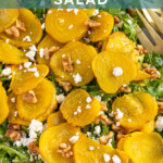 Pinterest pin with text "Golden Beet & Arugula Salad", image of a platter of arugula with roasted beets, walnuts, and feta cheese.