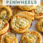 Pinterest pin with text 'Pesto Pinwheels', image of a pesto puff pastry pinwheel on a platter.