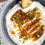 Pinterest pin with logo 'The Schmidty Wife', image of a bowl filled with whipped feta dip and honey.