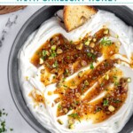 Pinterest pin with text overlay 'Whipped Feta with Garlicky Honey', image of a bowl with whipped feta dip and honey.