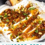 Pinterest pin with text overlay 'Whipped Feta with Garlicky Honey', image of a bowl with whipped feta dip and honey.