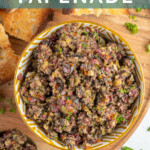 Pinterest Pin with text overlay 'Olive Tapenade', image of a yellow and white bowl filled with freshly made olive tapenade.