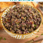 Pinterest Pin with text overlay 'Olive Tapenade', image of a yellow and white bowl filled with freshly made olive tapenade.