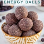 Pinterest Pin with text overlay "Blueberry Energy Balls", image of a bowl of purple blueberry energy balls.