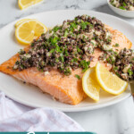 Pinterest pin with text overlay "Salmon with Olive Tapenade" with image of a plate of salmon topped with olive tapenade.