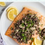Pinterest pin with text overlay "Salmon with Olive Tapenade" with image of a plate of salmon topped with olive tapenade.