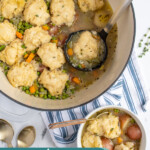 Pinterest pin with text overlay 'Veggie Dumpling Soup', image of a large pot filled with veggie dumpling soup.