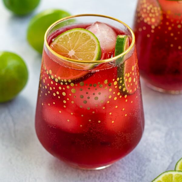 Hibiscus Iced Tea Sparkler in a glass with ice and limes