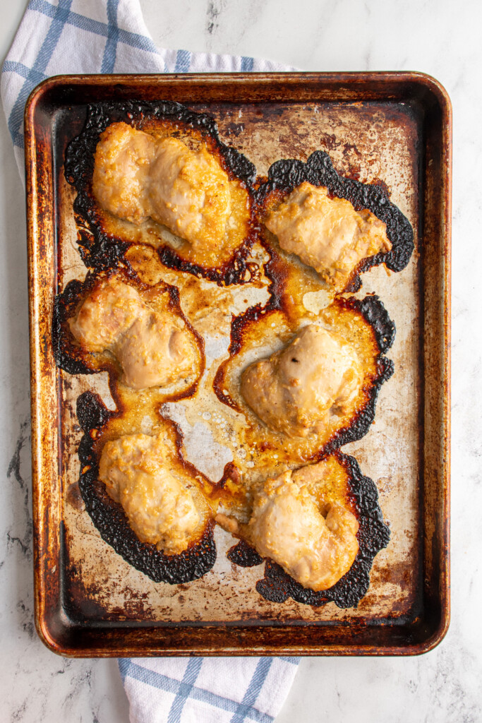 Sheet pan with baked lemongrass chicken on it.