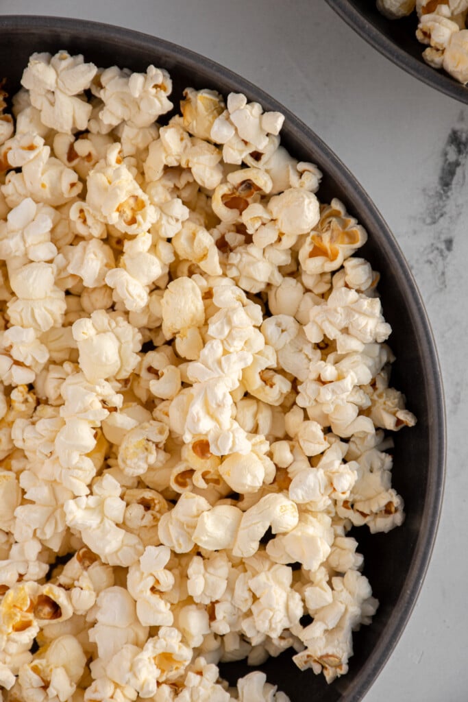 Large gray bowl filled with freshly popped stovetop popcorn.