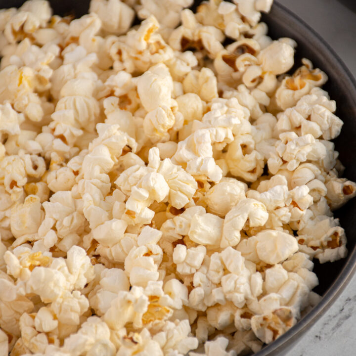 Close up of a gray bowl filled with popcorn made on the stovetop.