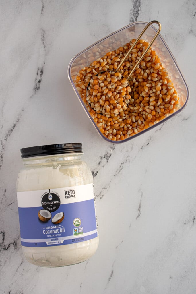 The two ingredients you need to make stovetop popcorn, coconut oil and popcorn kernels.