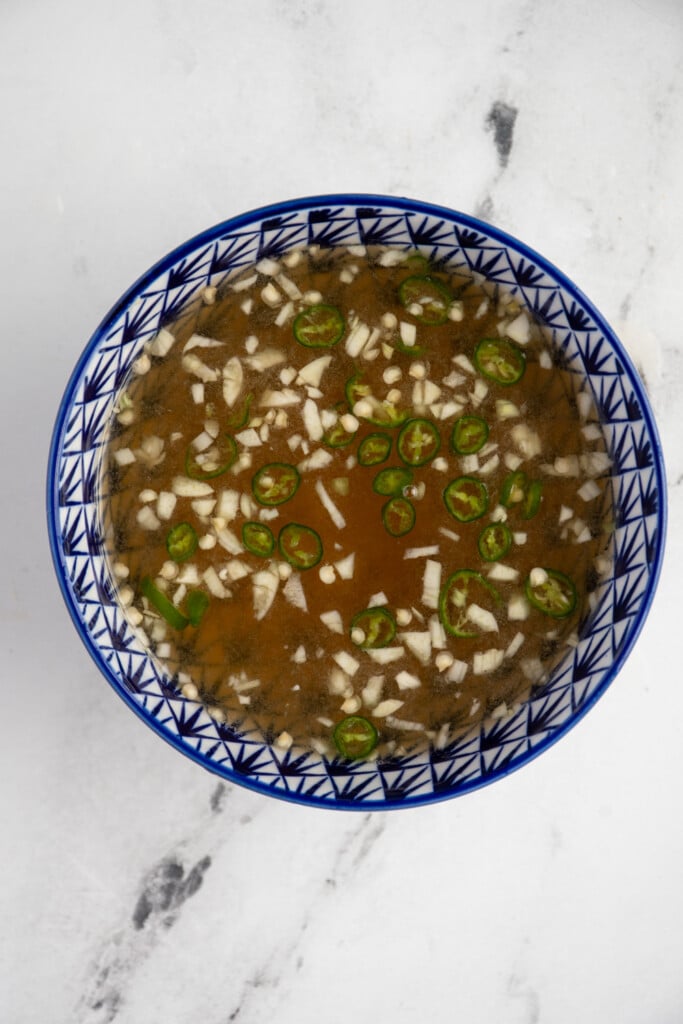 Blue and white bowl filled with fresh Mae nuoc Cham.