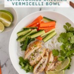 Pinterest pin with text overlay "Vietnamese Lemongrass Chicken Vermicelli Bowls", image of a white bowl filled with vermicelli noodles, lemongrass chicken, vegetables, and nuoc cham.