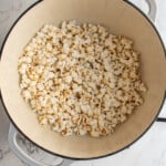 Pinterest pin with logo overlay 'The Schmidty Wife', image of a pot filled with freshly popped popcorn.