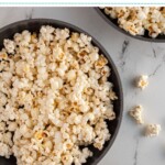 Pinterest pin with text overlay "How to Make Stovetop Popcorn", image of a gray sewing bowl filled with stovetop popcorn.