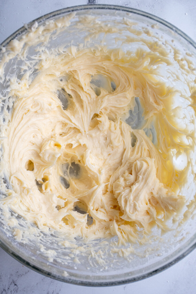 Freshly whipped up cream cheese frosting in a bowl for the carrot cake.