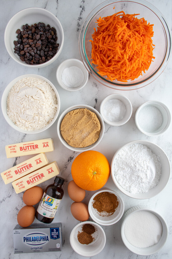 All of the ingredients needed to make easy carrot cake laid out on a table top.