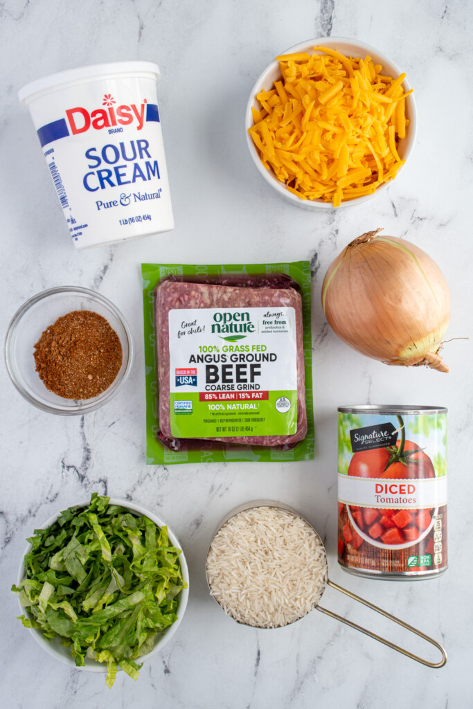 Ingredients to make taco rice skillet on a table top.