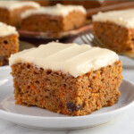 Pinterest pin with text overlay "Easy Homemade Carrot Cake", image of a slice of orange spiced carrot cake with cream cheese frosting on a plate.