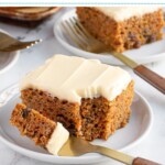 Pinterest pin with text overlay "Easy Homemade Carrot Cake", image of a slice of orange spiced carrot cake with cream cheese frosting on a plate.