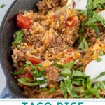 Pinterest pin with text overlay "Taco Rice Skillet" with image of taco rice skillet made in a cast iron.