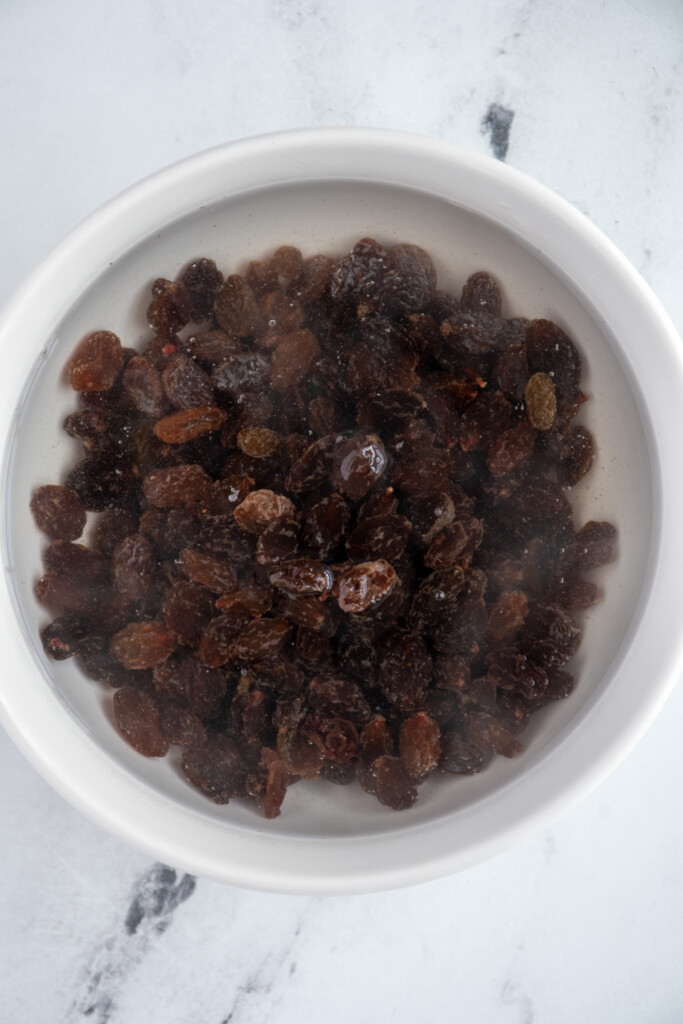 A bowl with raisins and warm water so that they have time to soak.