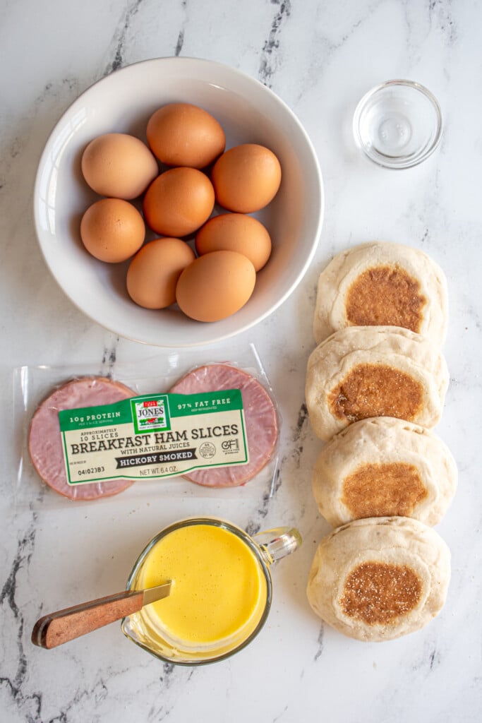 Ingredients needed to make easy eggs Benedict laid out on a table top.