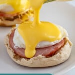 Pinterest pin with text overlay "Blender Hollandaise Sauce", image of easy hollandaise sauce poured over eggs Benedict.