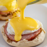 Pinterest pin with text overlay "Easy Blender Hollandaise Sauce", image of hollandaise sauce poured over eggs Benedict.