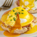 Pinterest pin with text overlay "Easy Eggs Benedict", image of eggs Benedict on a white plate.