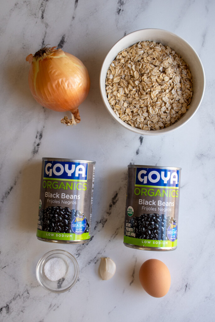 Ingredients needed to make grilled black bean burgers on a tabletop.