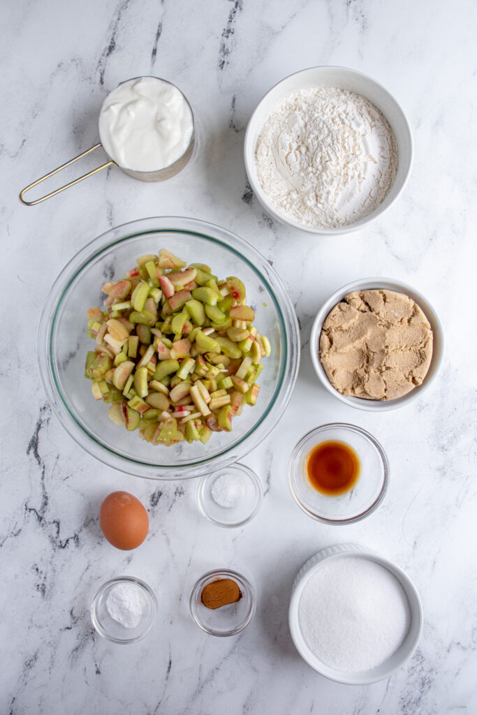 Ingredients needed to make rhubarb coffee cake on a tabletop.