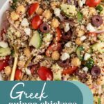 Pinterest pin with text overlay "Greek Quinoa Chickpea Salad", image of a white bowl filled with greek quinoa salad with chickpeas.