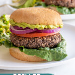 Pinterest pin with text overlay "Grilled Black Bean Burgers", image of a grilled black bean burger in a bun.