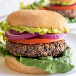 Pinterest pin with text overlay "Grilled Black Bean Burgers", image of a grilled black bean burger in a bun.