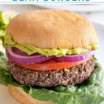 Pinterest pin with text overlay "Grilled Black Bean Burgers", image of a grilled black bean burger in a bun.