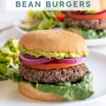 Pinterest pin with text overlay "Grilled Black Bean Burgers", image of a grilled black bean burger in a bun.